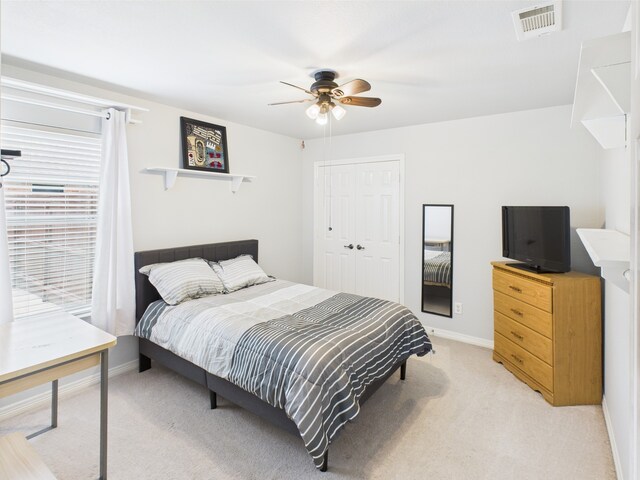 bedroom with visible vents, baseboards, and light colored carpet
