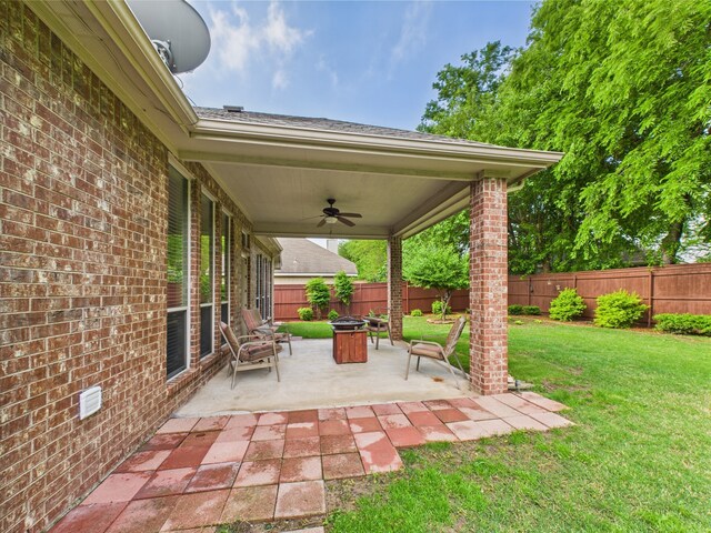 view of patio / terrace featuring a fire pit, a ceiling fan, and a fenced backyard