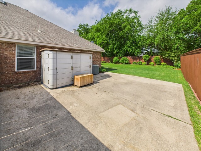garage with fence and central air condition unit