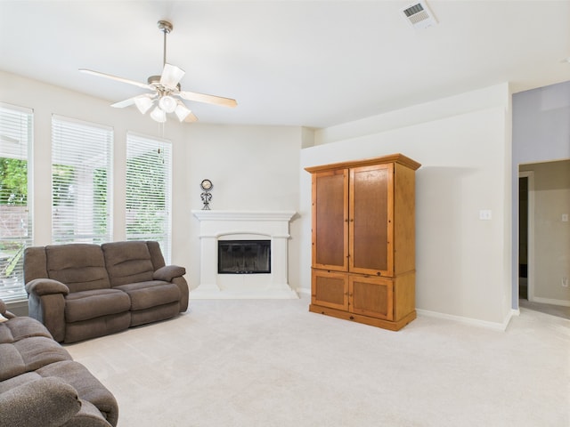 733 Willow Crest Dr, Midlothian, TX 76065 - living area with a ceiling fan, light colored carpet, a glass covered fireplace, and baseboards