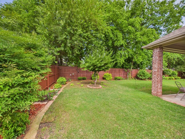 view of yard featuring a patio and a fenced backyard
