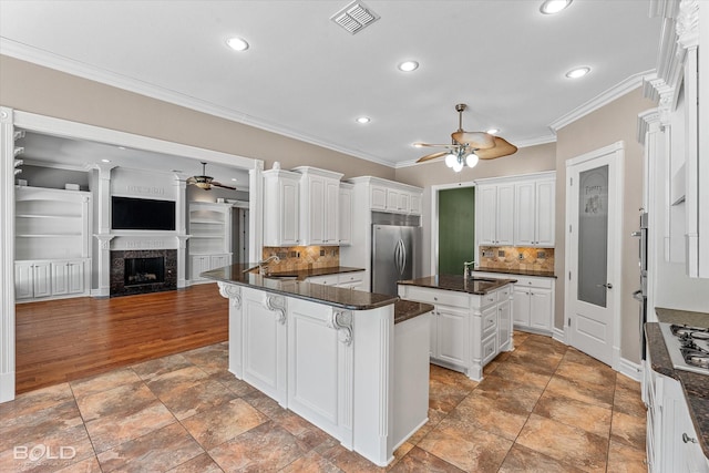 11 Chapel Creek Ln, Shreveport, LA 71106 - kitchen with a ceiling fan, appliances with stainless steel finishes, recessed lighting, crown molding, and a sink