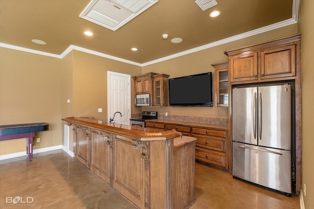 11 Chapel Creek Ln, Shreveport, LA 71106 - kitchen with appliances with stainless steel finishes, a peninsula, brown cabinetry, ornamental molding, and glass insert cabinets