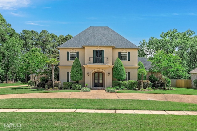 11 Chapel Creek Ln, Shreveport, LA 71106 - french country inspired facade featuring french doors, a balcony, stucco siding, and roof with shingles