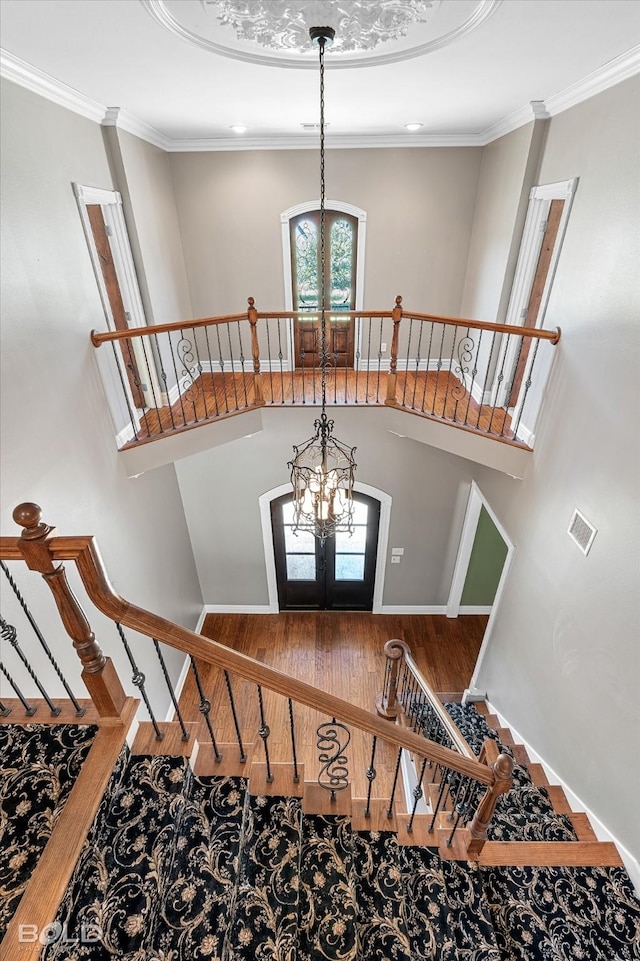 11 Chapel Creek Ln, Shreveport, LA 71106 - stairway with wood finished floors, a chandelier, baseboards, and ornamental molding