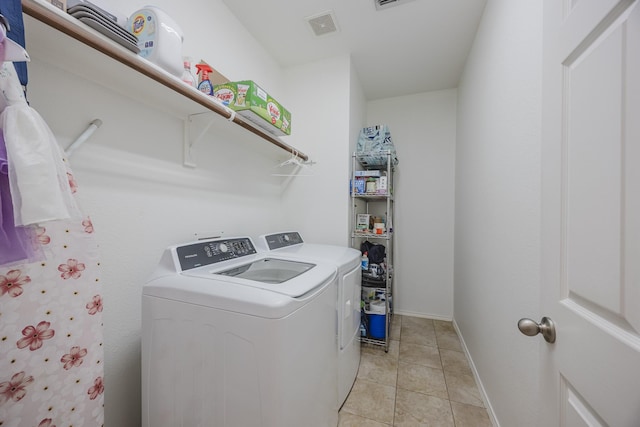 3949 Sunnygate Dr, Fort Worth, TX 76262 - laundry area with washer and clothes dryer and light tile patterned flooring