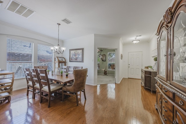 3949 Sunnygate Dr, Fort Worth, TX 76262 - dining room featuring a chandelier, ornamental molding, light wood-style floors, and baseboards