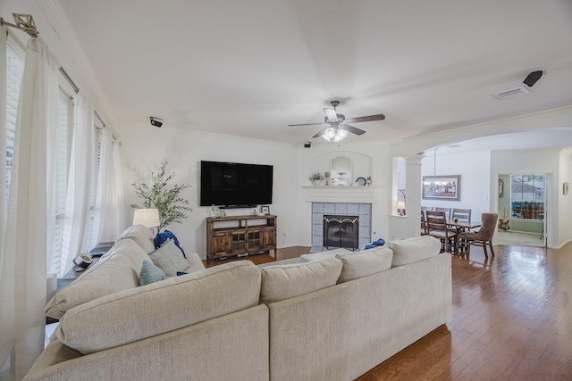 3949 Sunnygate Dr, Fort Worth, TX 76262 - living area with arched walkways, ornate columns, a ceiling fan, crown molding, and wood finished floors