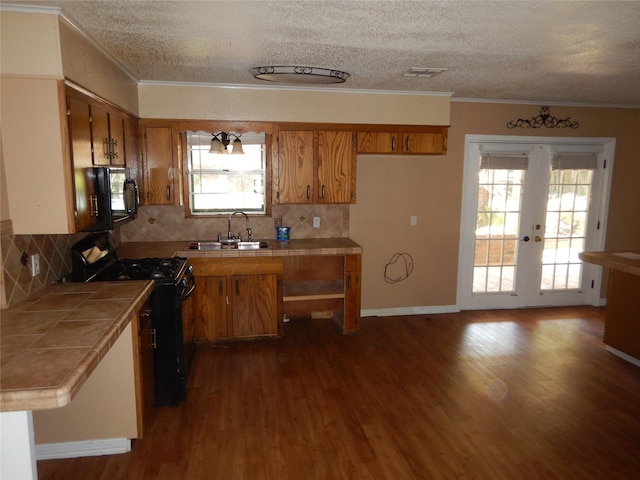 8157 Hobbs Dr, Shreveport, LA 71129 - kitchen featuring a sink, tile counters, brown cabinetry, and black appliances
