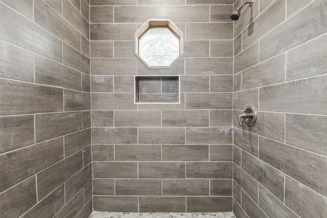 bathroom featuring tiled shower