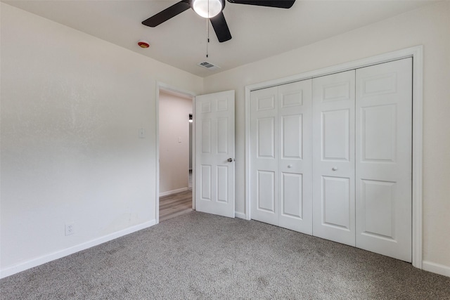 unfurnished bedroom with carpet floors, baseboards, visible vents, and a closet