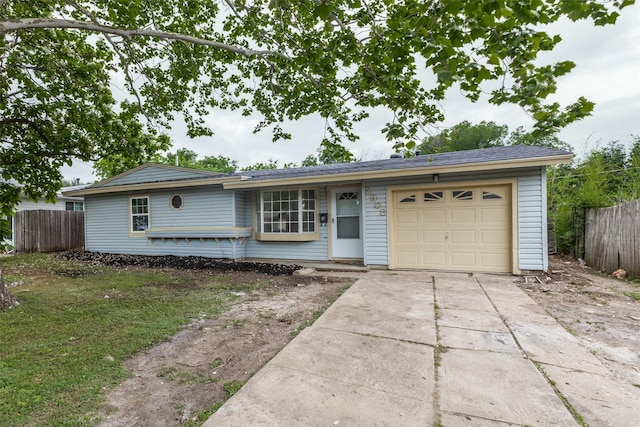 single story home with fence, an attached garage, and driveway