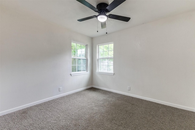 spare room with baseboards, carpet, and ceiling fan