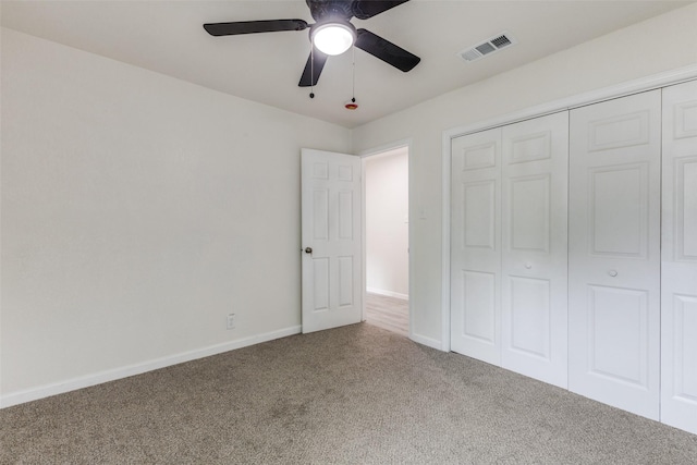 unfurnished bedroom with a ceiling fan, visible vents, baseboards, a closet, and carpet