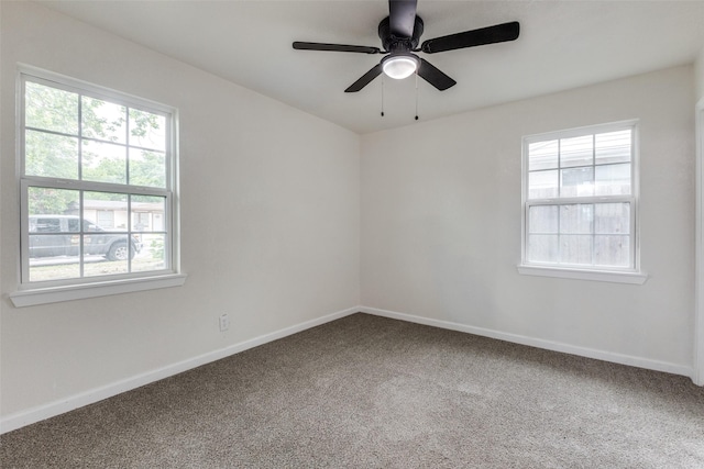 unfurnished room with baseboards, ceiling fan, carpet, and a wealth of natural light