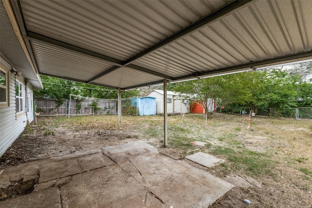 exterior space with a fenced backyard, a storage unit, a patio, and an outdoor structure