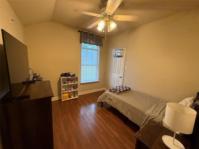 bedroom featuring baseboards, dark wood-style flooring, ceiling fan, and lofted ceiling