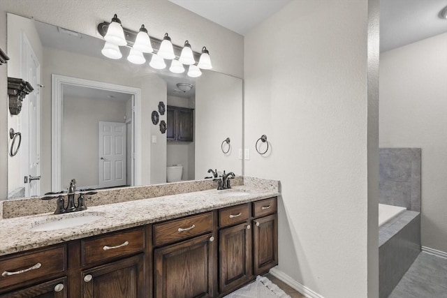4610 Bluebird Ln, Mansfield, TX 76063 - full bath with baseboards, double vanity, toilet, and a tub