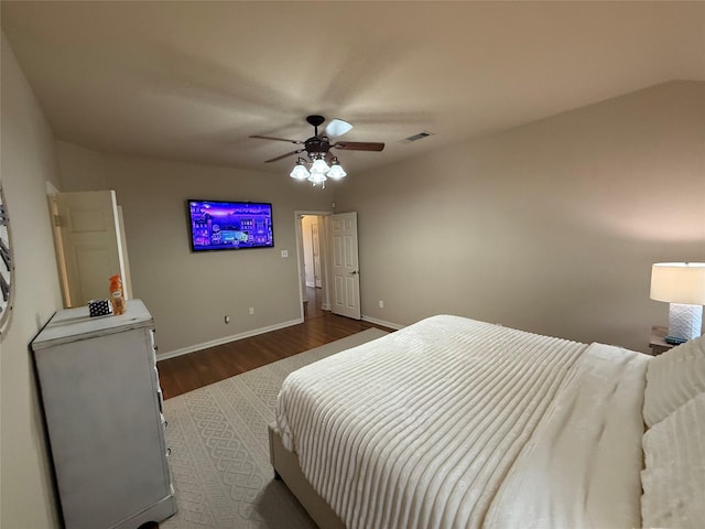 bedroom featuring a ceiling fan, baseboards, visible vents, and wood finished floors