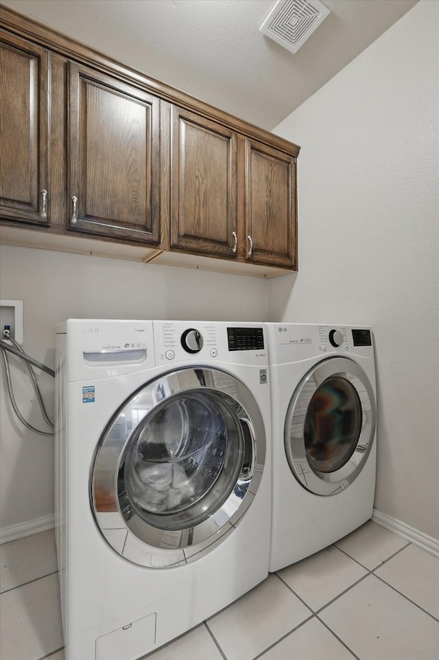 4610 Bluebird Ln, Mansfield, TX 76063 - washroom featuring cabinet space, light tile patterned floors, baseboards, and separate washer and dryer