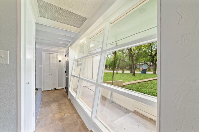 hall with visible vents and concrete floors