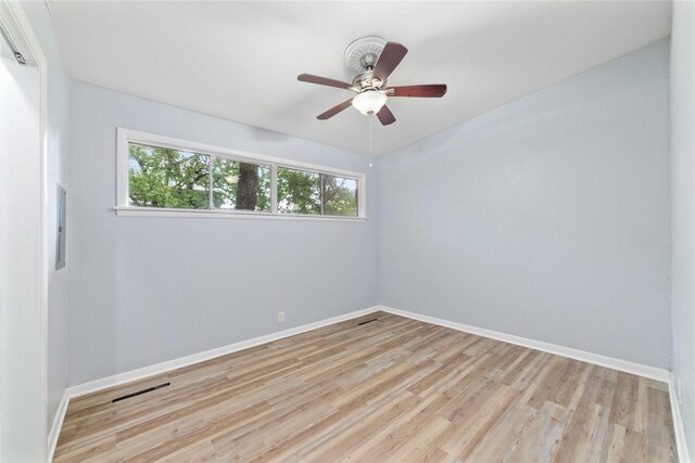 unfurnished room with baseboards, visible vents, ceiling fan, and light wood finished floors
