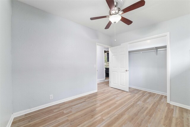 unfurnished bedroom featuring baseboards, ceiling fan, light wood-style flooring, and a closet
