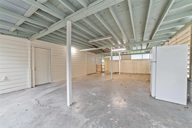 basement featuring freestanding refrigerator