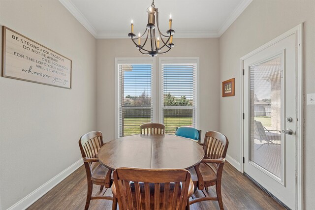 dining room featuring baseboards, a chandelier, dark wood-style floors, and ornamental molding