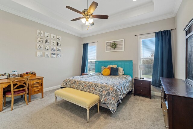 bedroom featuring crown molding, a tray ceiling, light carpet, and multiple windows