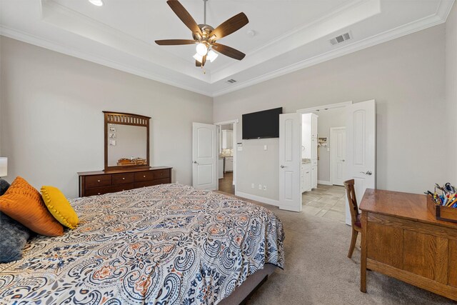 bedroom with carpet floors, visible vents, ornamental molding, and a raised ceiling