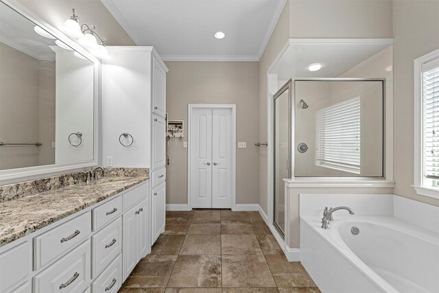 bathroom featuring a garden tub, a stall shower, vanity, baseboards, and ornamental molding