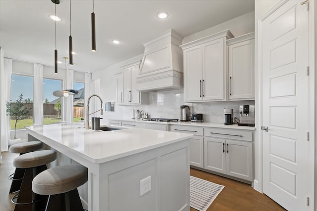 3320 Alexandra Ln, Celina, TX 75009 - kitchen with custom range hood, a sink, a center island with sink, backsplash, and light countertops
