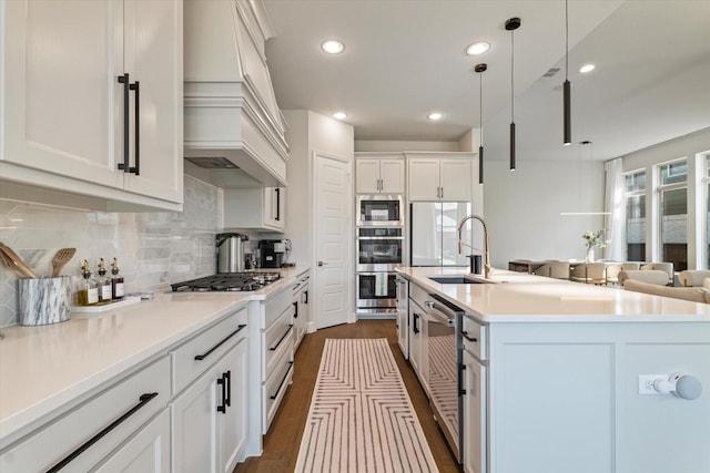 3320 Alexandra Ln, Celina, TX 75009 - kitchen with a sink, premium range hood, stainless steel appliances, dark wood-style flooring, and decorative backsplash