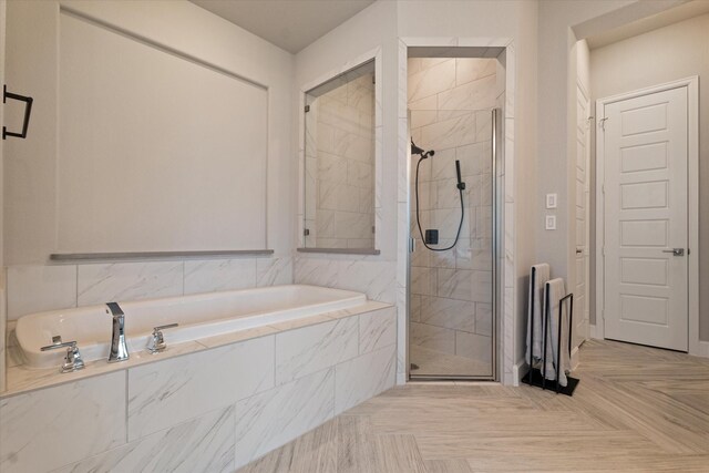 ensuite bathroom featuring ceiling fan, two vanities, and a sink