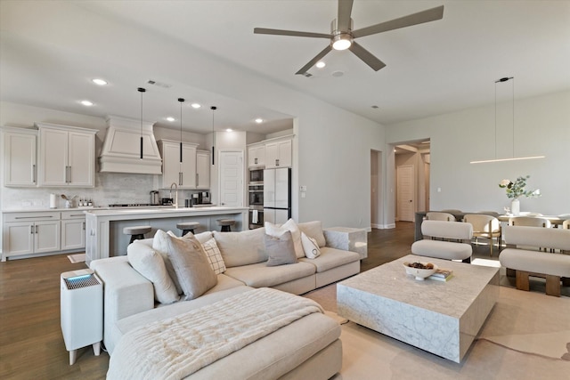 living area with visible vents, recessed lighting, ceiling fan, and wood finished floors