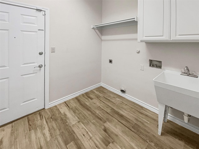 laundry area featuring electric dryer hookup, cabinet space, baseboards, hookup for a washing machine, and light wood-style floors