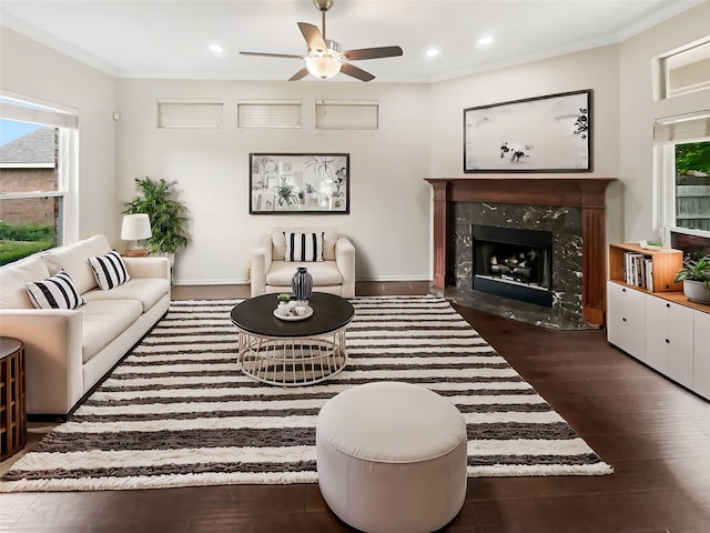 living area featuring a premium fireplace, ceiling fan, recessed lighting, and a wealth of natural light