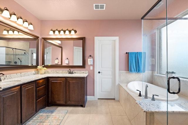 bathroom with a sink, double vanity, tile patterned floors, a bath, and a stall shower
