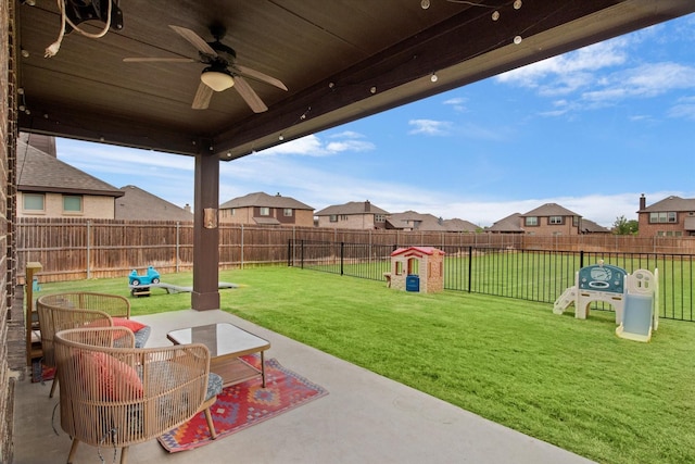 view of patio / terrace with a ceiling fan, a fenced backyard, and a residential view