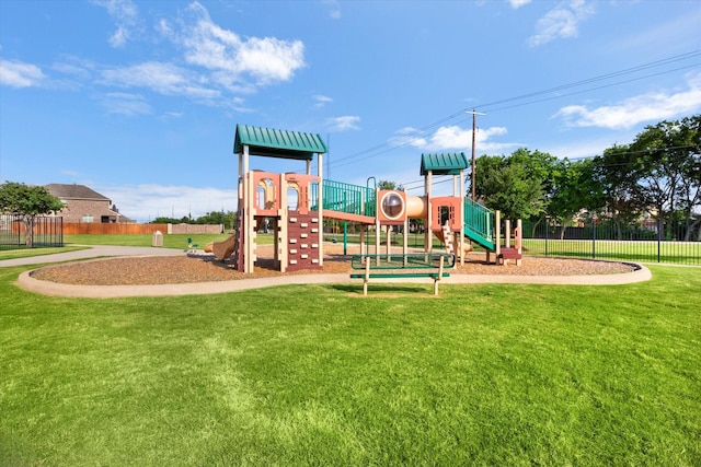 communal playground featuring fence and a yard