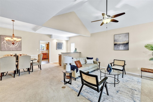 living area with baseboards, carpet, ceiling fan with notable chandelier, and lofted ceiling
