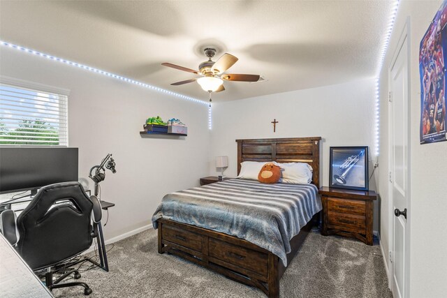 bedroom featuring carpet floors, a ceiling fan, and baseboards