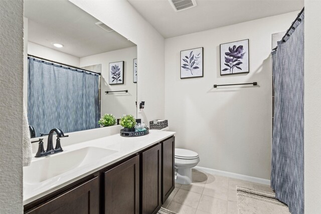 full bath featuring visible vents, vanity, toilet, baseboards, and tile patterned floors