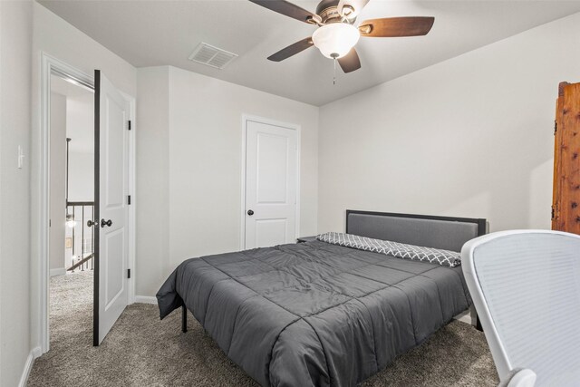 carpeted bedroom featuring visible vents, a ceiling fan, and baseboards