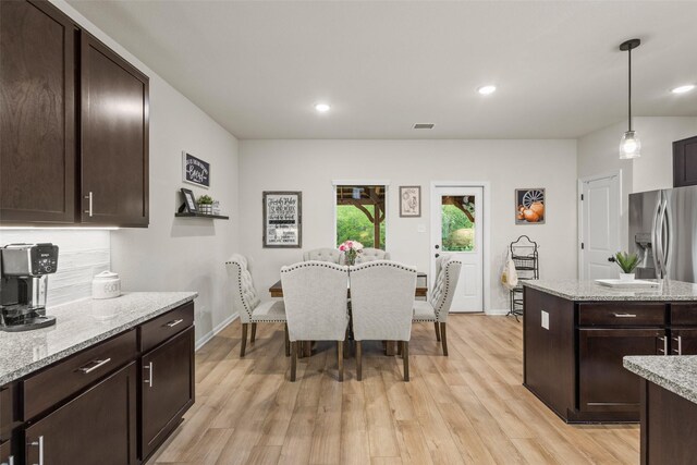 dining area with light wood-style floors, recessed lighting, and visible vents