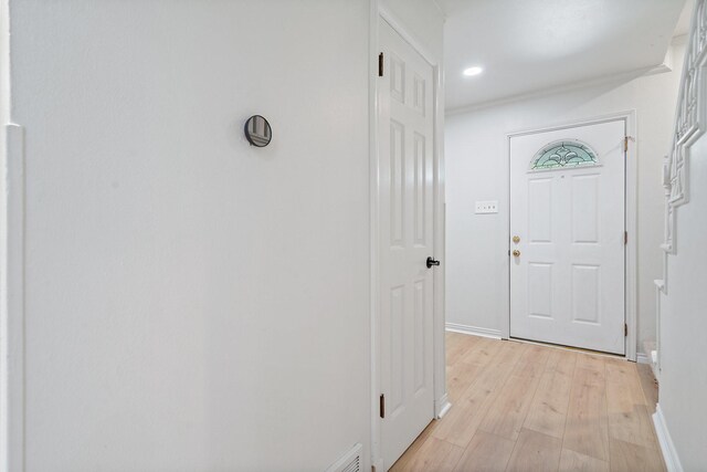 interior space featuring recessed lighting, baseboards, and light wood finished floors