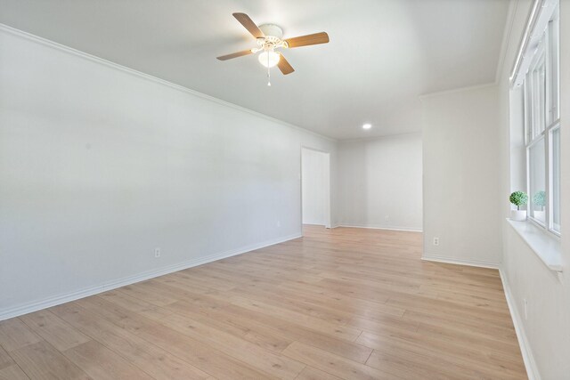 unfurnished room featuring crown molding, baseboards, ceiling fan, and light wood finished floors