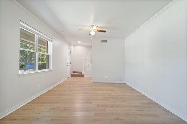 unfurnished room with crown molding, ceiling fan, stairs, and visible vents
