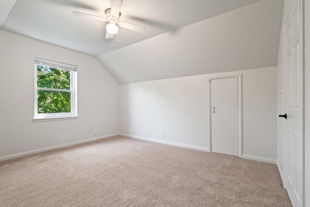 bonus room with ceiling fan, vaulted ceiling, baseboards, and carpet